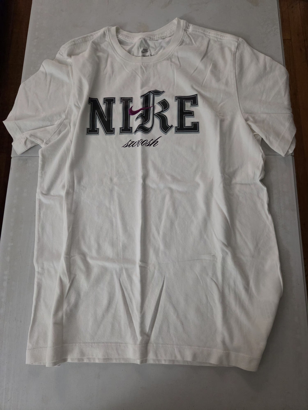 Nike White Short Sleeve Tee with Black Lettering and Pink Swoosh
